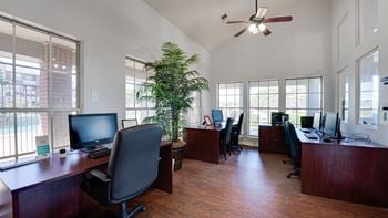 Brown color floor, computer and chair